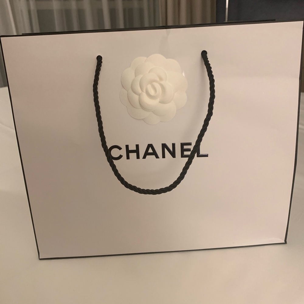 Brand new rare and collectible authentic Chanel with bow paper shopping bag.